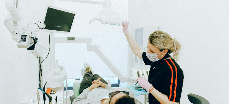 a dentist doing her job after relocating medical equipment in Bay Area 