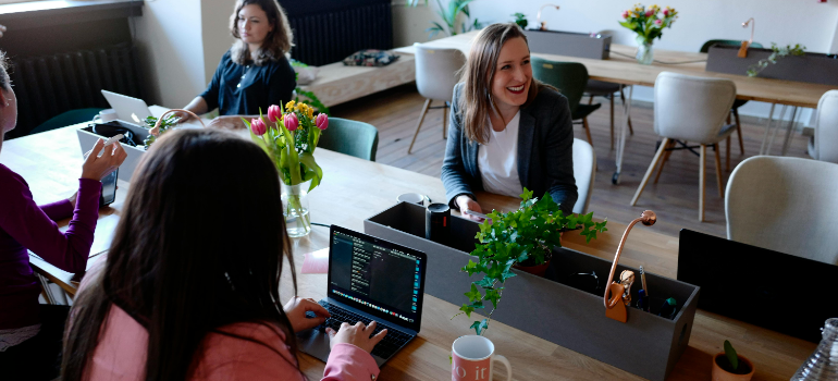 happy employees talking about reasons you need to move to a new office