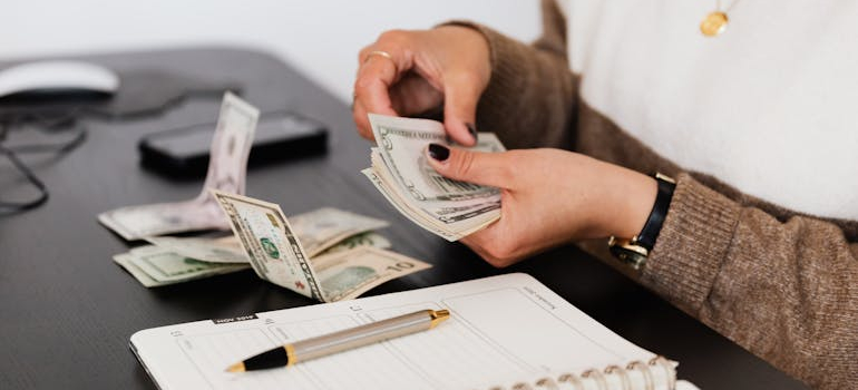 a person setting a side a budget as they are planning on moving to the Bay Area for a job