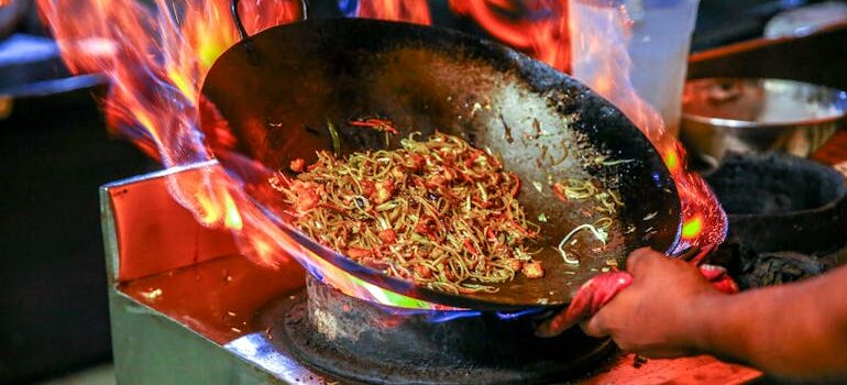 a person cooking Chinese food