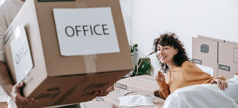 Man Carrying A Box Of Office Materials