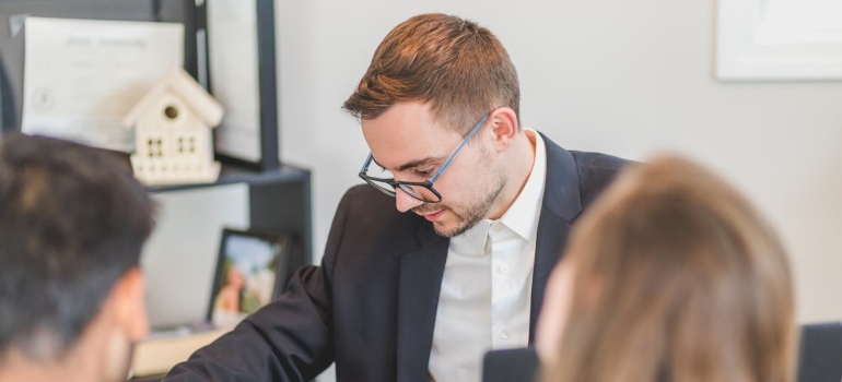 a real estate agent discussing in front of his clients