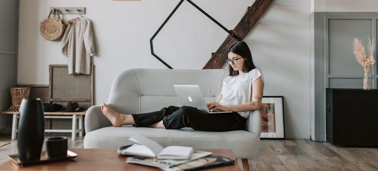  young woman using laptop in modern living room