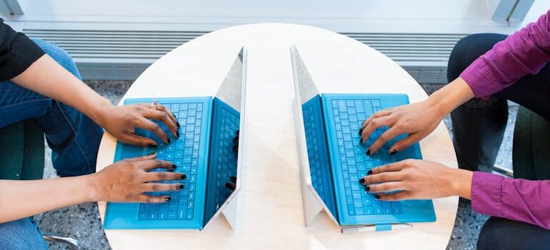 Two People Working on Laptops