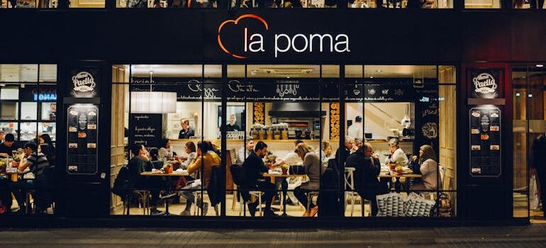 People at La Poma Store Front at Night