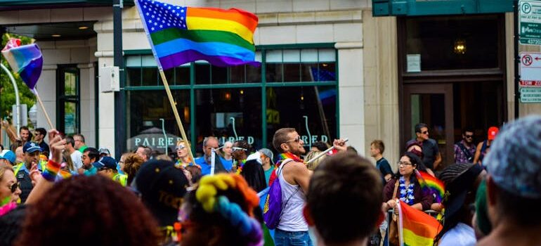 eople Gathered Near Building Holding Flag at Daytime