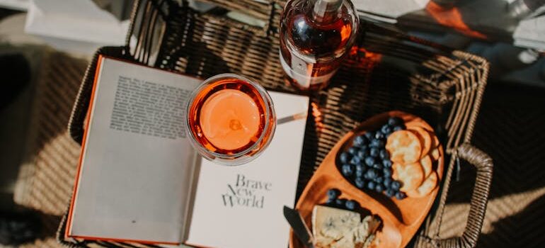 Wine Bottle, Cheese and Book in Basket