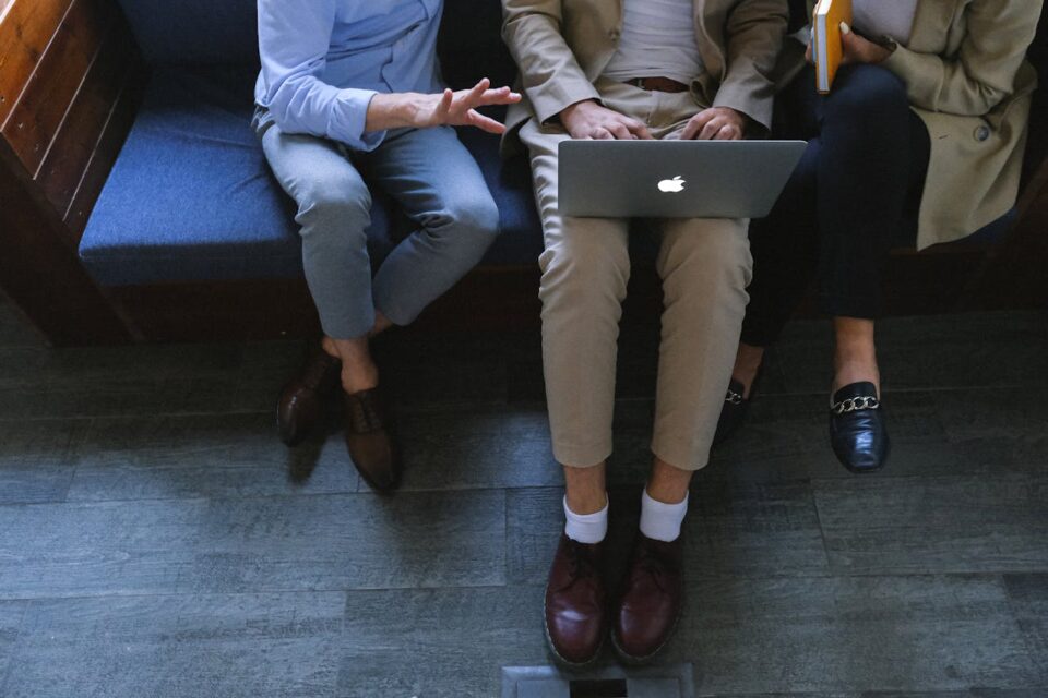 Three People Using Laptop together