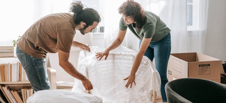 Couple Packing Up A Chair
