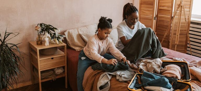 Mother and Daughter Folding Clothes