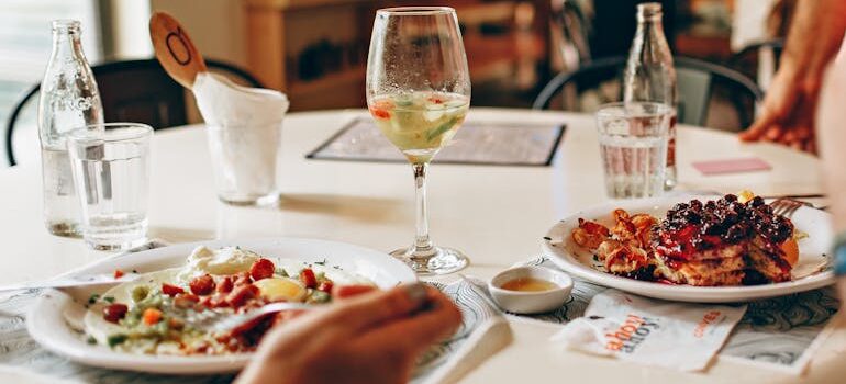 Wine in Clear Glass Near Food on Plate on Table